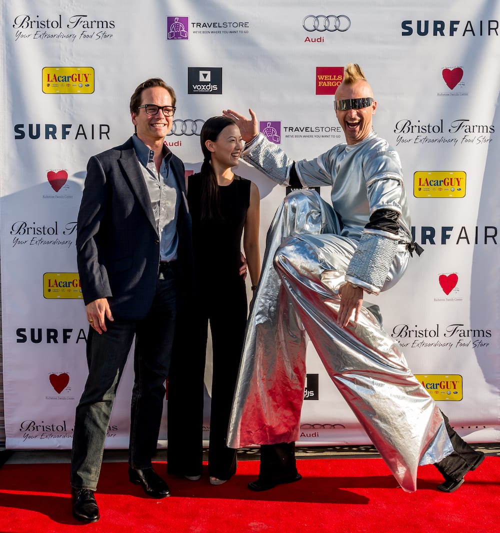 Dr. Jay Granzow, MD, and his wife at an event with a man dressed in a bright silver suit.
