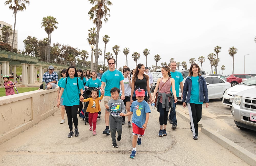 Dr. Jay Granzow, MD, walks with a group of people at the annual run/walk to Fight lymphedema and lymphatic diseases.