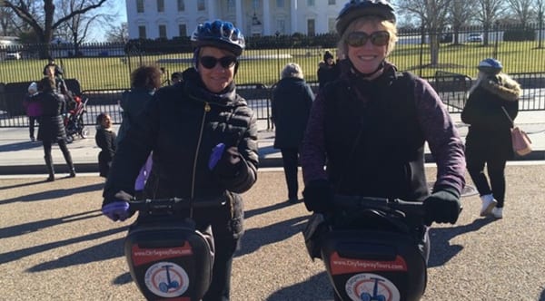Charlotte, a patient of Dr. Jay Granzow, MD, rides a segway with a friend outside of the White House.